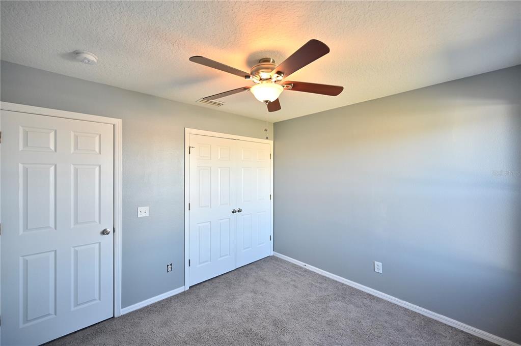 10922 Subtle Trail Drive Riverview, FL 33579 - Photo 29 of 60 an empty room with closet and a ceiling fan