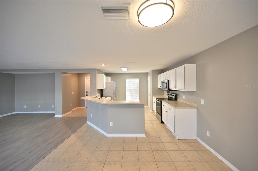 10922 Subtle Trail Drive Riverview, FL 33579 - Photo 42 of 60 a large kitchen with cabinets