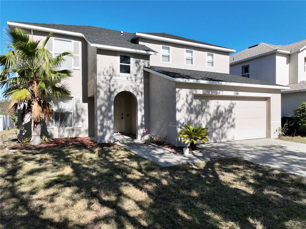 10922 Subtle Trail Drive Riverview, FL 33579 - Photo 58 of 60 a view of a house with potted plants and a floor to ceiling window