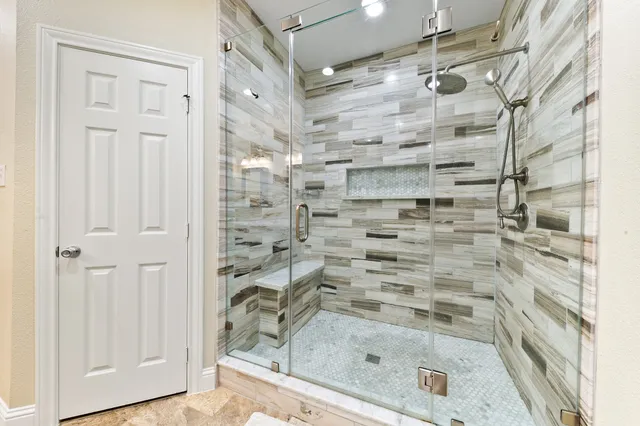 a bedroom with a large bed and a chandelier