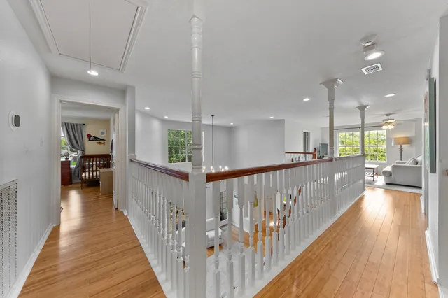 a spacious bathroom with a granite countertop sink a toilet a mirror and bathtub