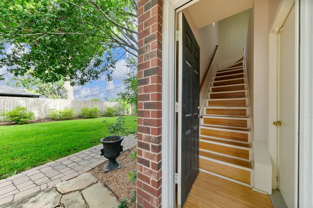 a dining room with furniture a chandelier and wooden floor
