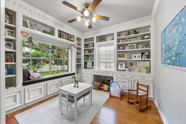 a reading room with furniture wooden floor and a window