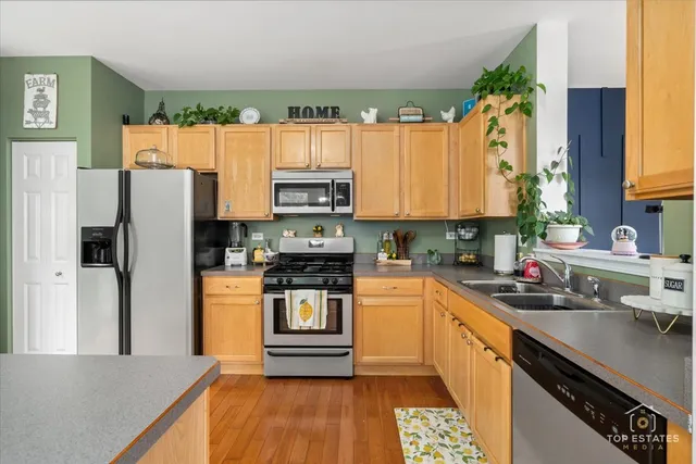 a kitchen with stainless steel appliances a refrigerator sink and cabinets