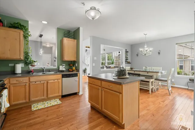 a kitchen with stainless steel appliances granite countertop a stove and cabinets