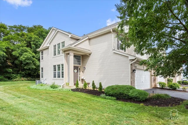 a view of a house with yard and a garden