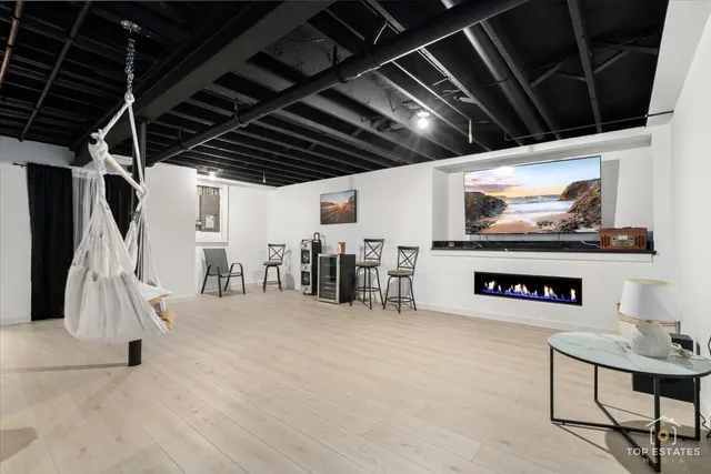 a view of a hall with an entryway and fireplace