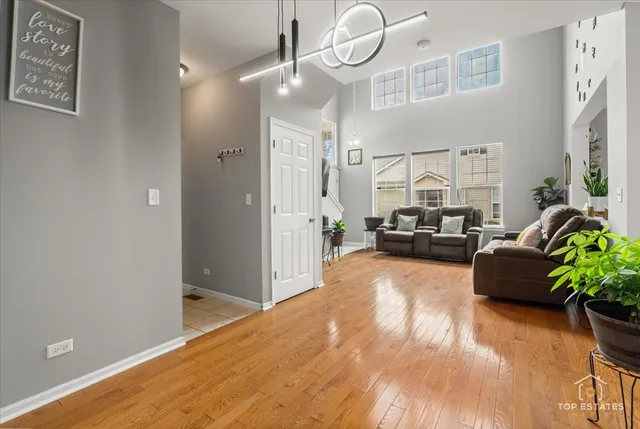 a living room with furniture and a chandelier
