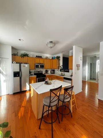a large kitchen with a table and chairs