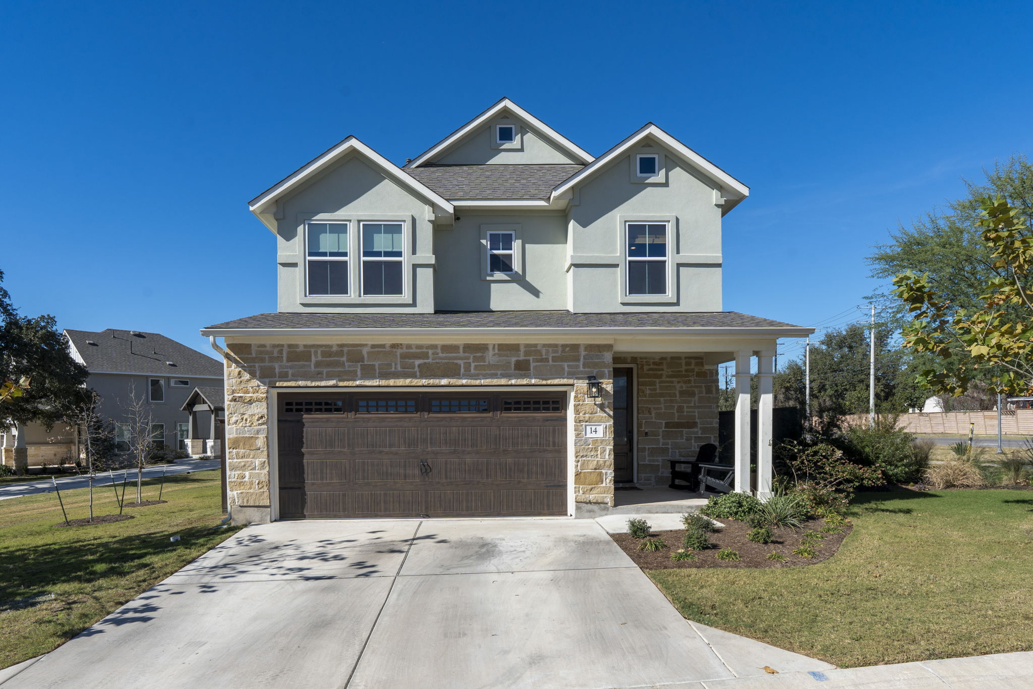 a front view of a house with a garden