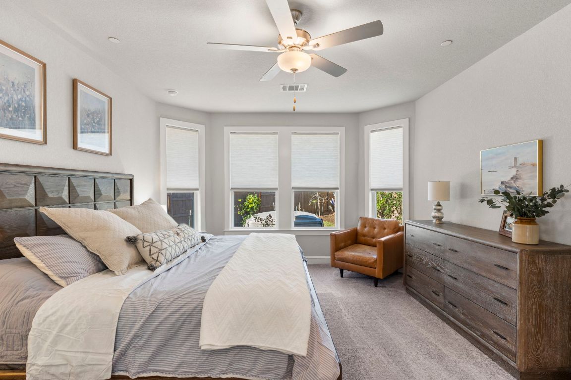 2605 Sam Bass Road, Unit 14 Round Rock, TX 78681 - Photo 12 of 30 a spacious bedroom with a large bed and a window