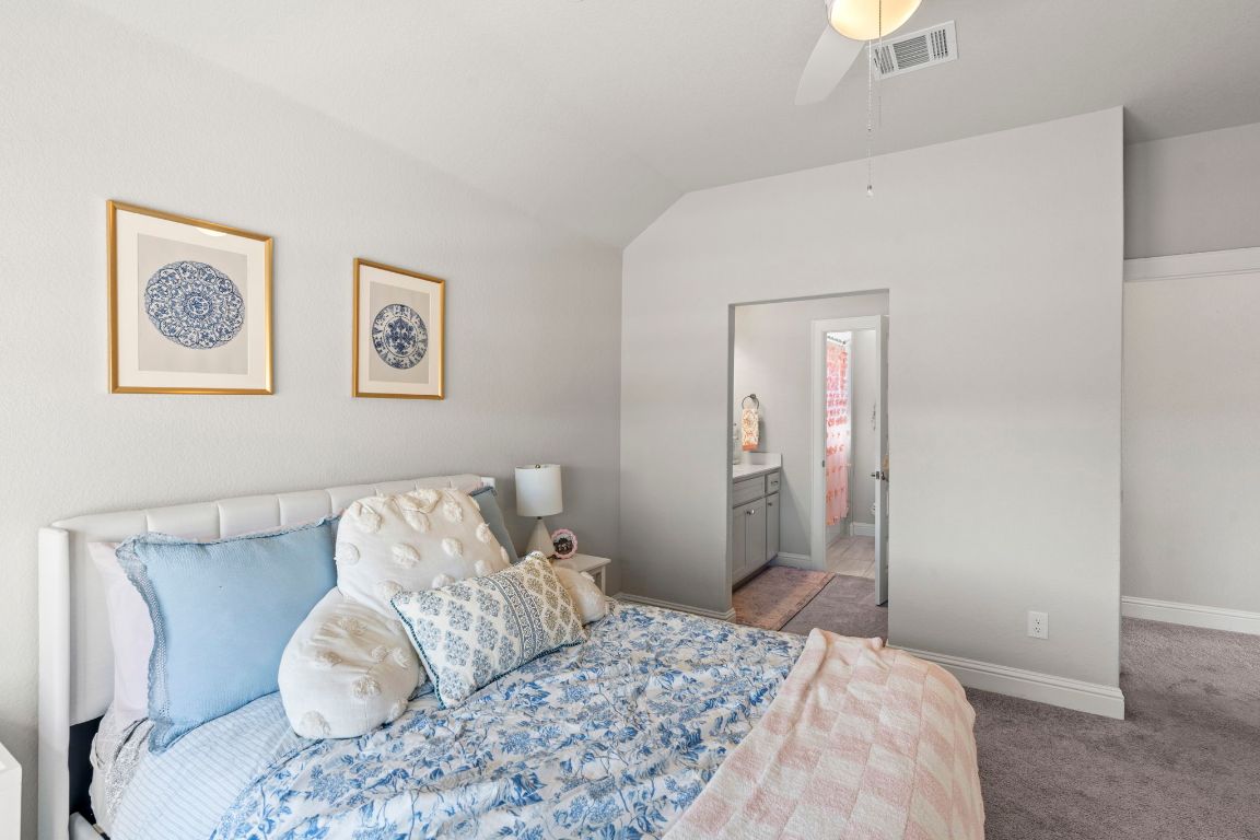 2605 Sam Bass Road, Unit 14 Round Rock, TX 78681 - Photo 19 of 30 a bedroom with a bed and a painting on the wall