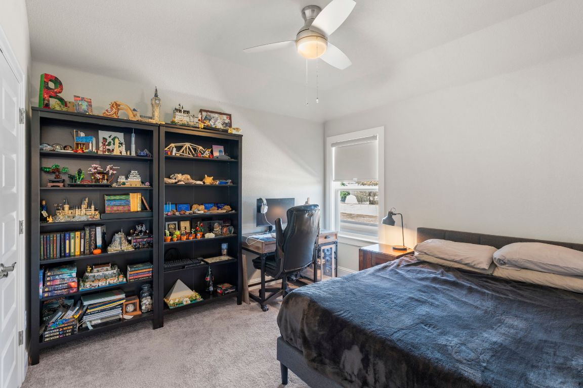 2605 Sam Bass Road, Unit 14 Round Rock, TX 78681 - Photo 24 of 30 a bedroom with bed and a book shelf