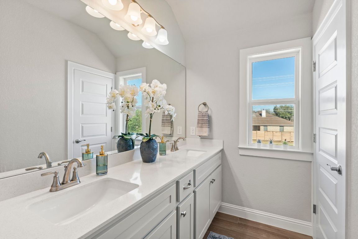 2605 Sam Bass Road, Unit 14 Round Rock, TX 78681 - Photo 25 of 30 a bathroom with a sink a large mirror and a window