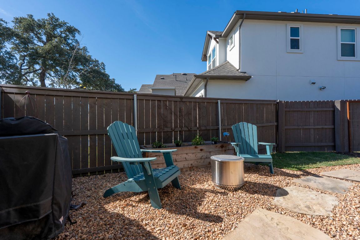 2605 Sam Bass Road, Unit 14 Round Rock, TX 78681 - Photo 27 of 30 a view of a chair and table in backyard