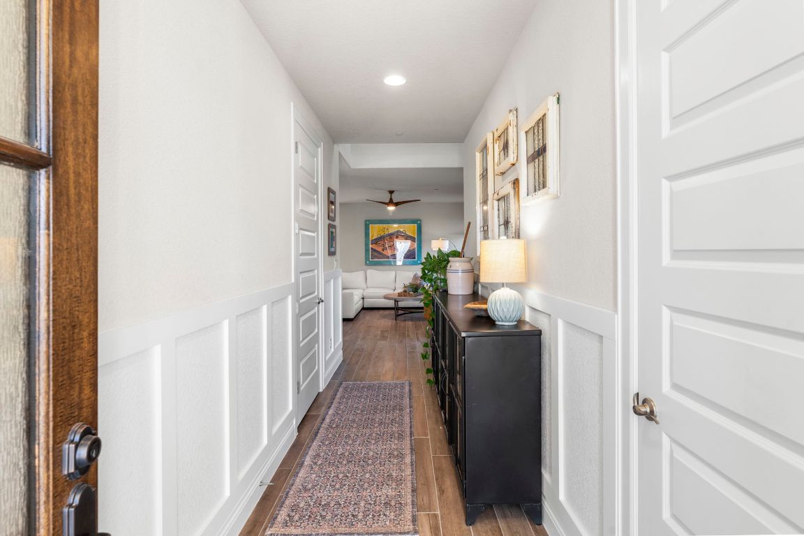 2605 Sam Bass Road, Unit 14 Round Rock, TX 78681 - Photo 4 of 30 a hallway with a dining table and chairs