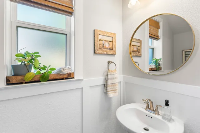 a bathroom with mirror and a sink