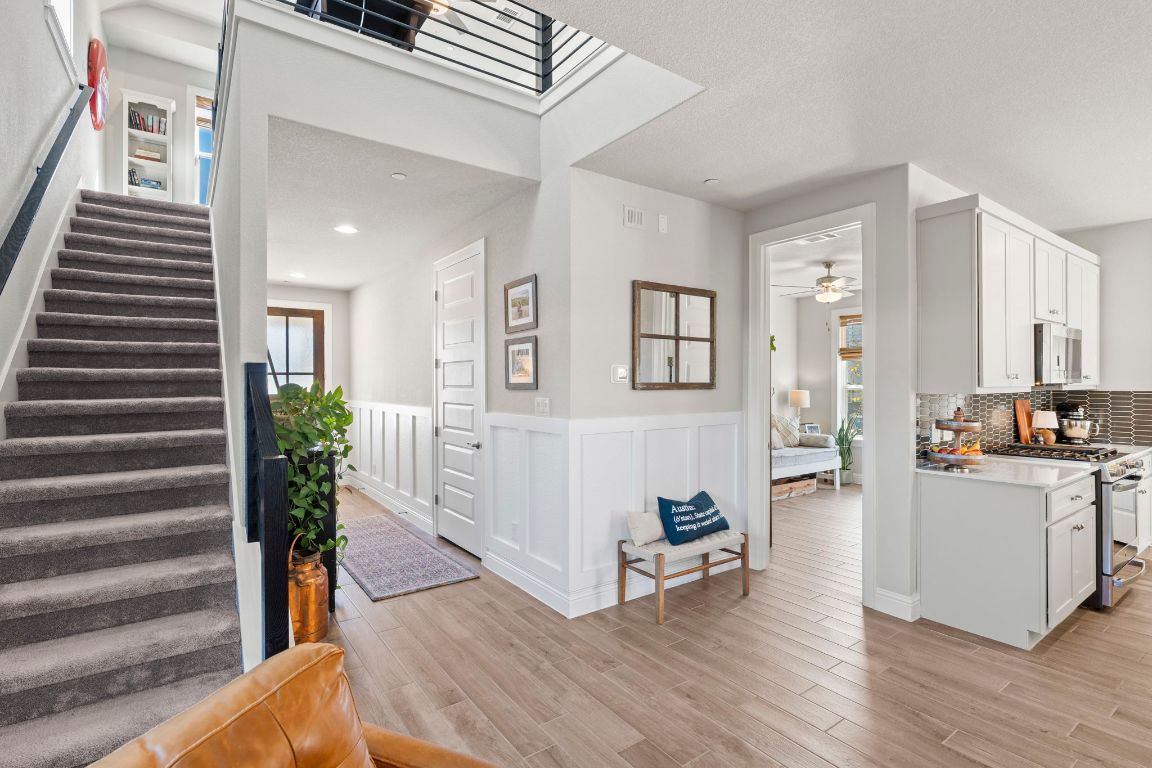 2605 Sam Bass Road, Unit 14 Round Rock, TX 78681 - Photo 30 of 30 a view of a living room and kitchen with furniture and wooden floor