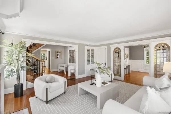 a living room with furniture and wooden floor