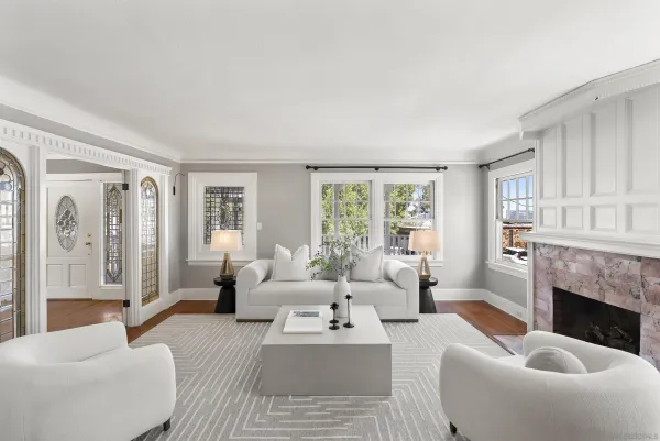a living room with furniture a large window and a fireplace