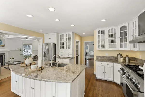 a kitchen with stainless steel appliances granite countertop a sink stove and cabinets