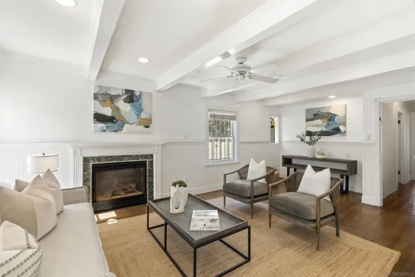 a living room with furniture a fireplace and wooden floor