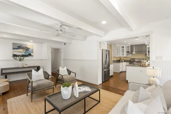 a living room with furniture and kitchen view