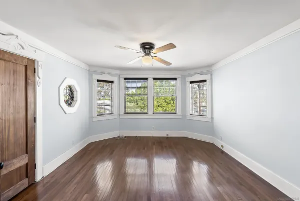 wooden floor in an empty room with a window