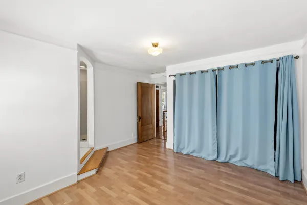 a view of a room with wooden floor