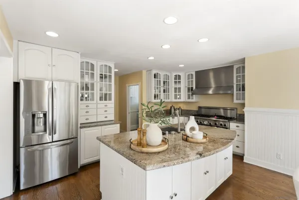 a kitchen with stainless steel appliances granite countertop a sink stove and refrigerator
