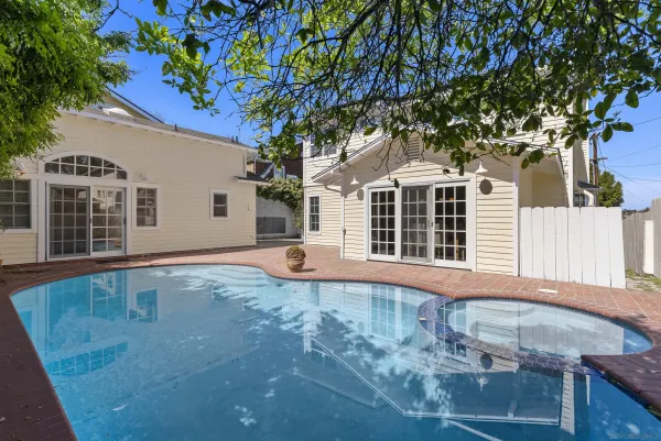 a view of a house with a backyard