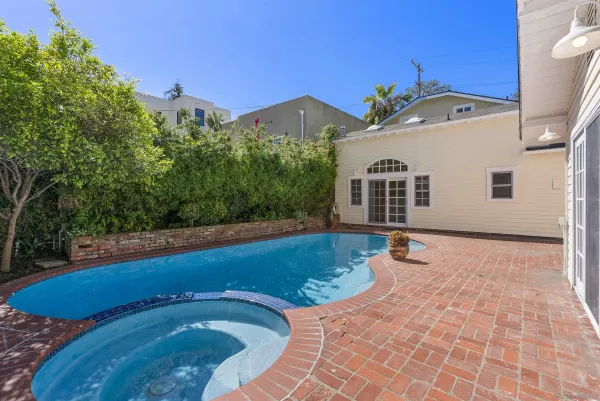 a view of a house with pool and a yard