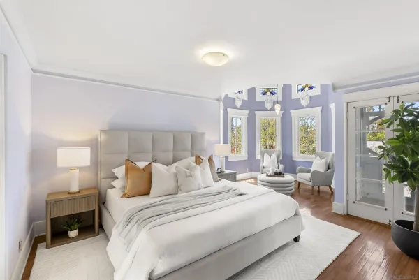 a bedroom with a large bed and a large window