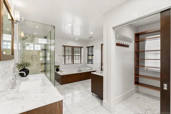 a large bathroom with a tub and shower