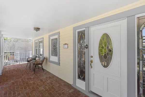 a view of a livingroom with furniture wooden floor windows and entryway