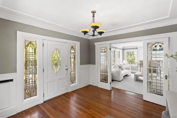 a view of an livingroom with furniture wooden floor and windows