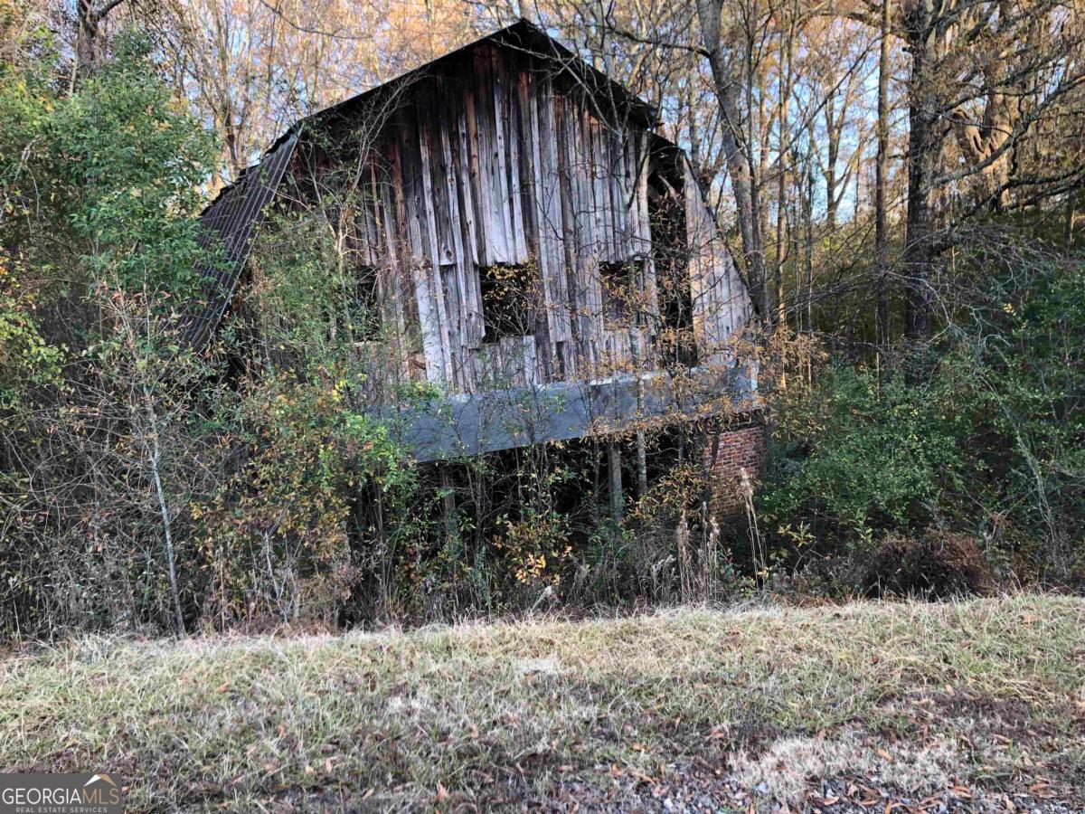 0 Monticello Road Eatonton, GA 31024 - Photo 3 of 15 a view of a small house with a tree in the yard