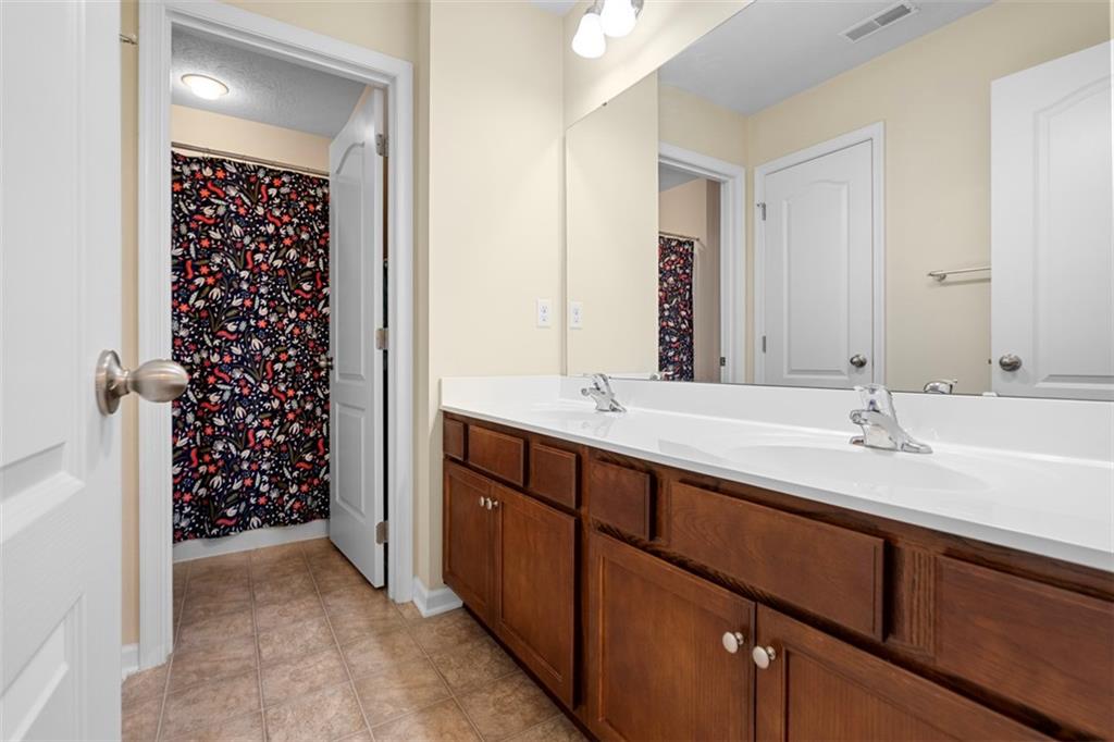 2284 Flint Drive Washington, PA 15301 - Photo 19 of 28 a bathroom with a double vanity sink a large mirror and shower