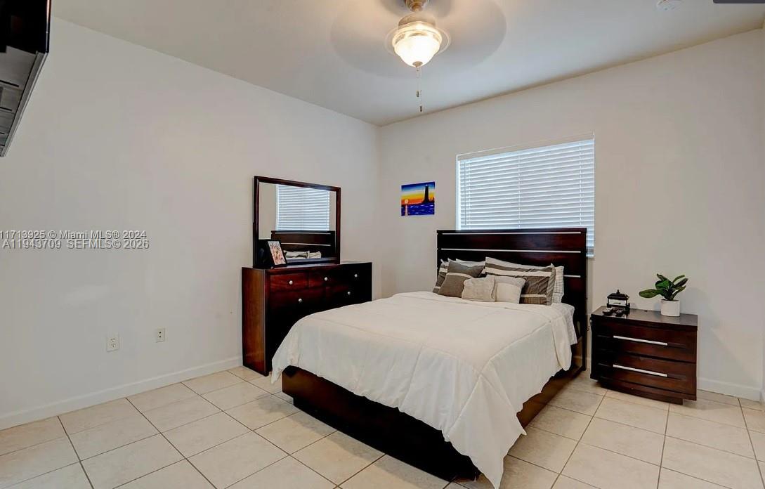 11410 Southwest 229th Terrace Miami, FL 33170 - Photo 26 of 36 a bedroom with a bed and a chandelier