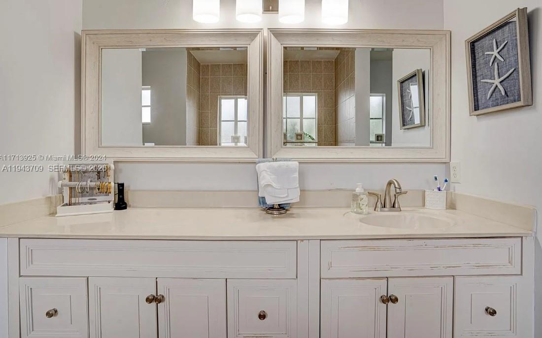 11410 Southwest 229th Terrace Miami, FL 33170 - Photo 35 of 36 a bathroom with double sink and a mirror
