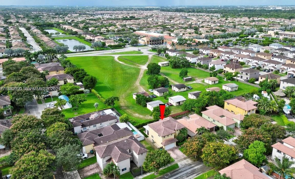 11410 Southwest 229th Terrace Miami, FL 33170 - Photo 6 of 36 an aerial view of a city with lots of residential buildings