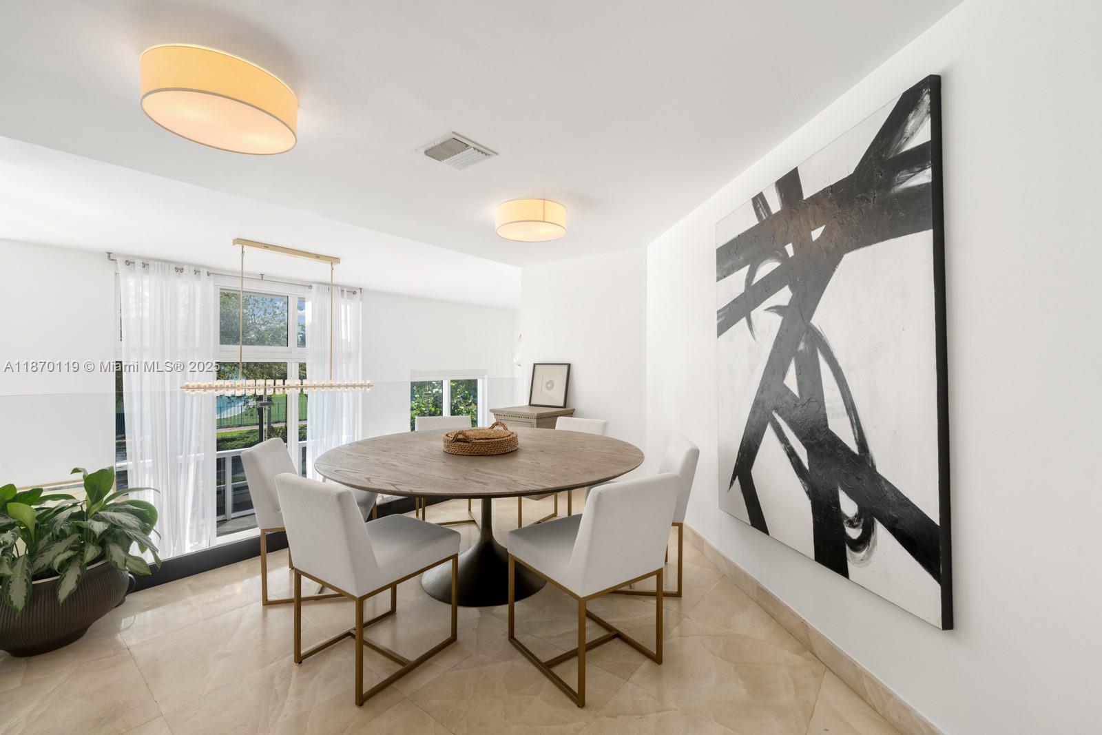 400 Alton Road, Unit TH1A Miami Beach, FL 33139 - Photo 12 of 45 a view of a dining room with furniture and a potted plant