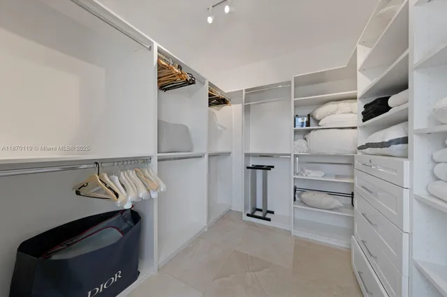 a white bath tub sitting next to a shower