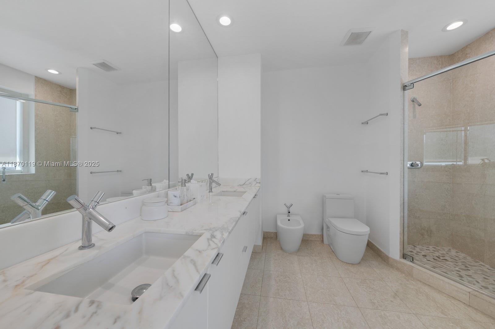 400 Alton Road, Unit TH1A Miami Beach, FL 33139 - Photo 21 of 45 a bathroom with a granite countertop sink mirror and toilet