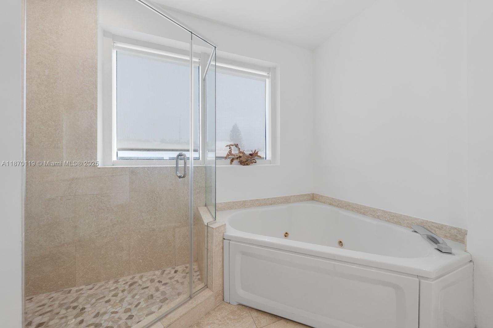 400 Alton Road, Unit TH1A Miami Beach, FL 33139 - Photo 22 of 45 a white bath tub sitting next to a shower