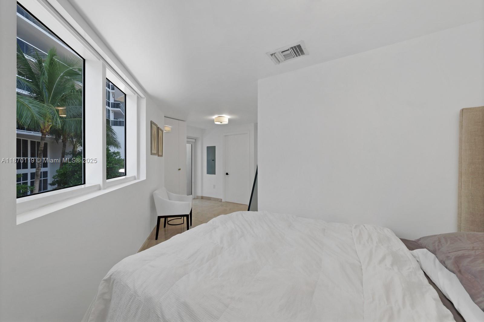 400 Alton Road, Unit TH1A Miami Beach, FL 33139 - Photo 26 of 45 a bedroom with a bed and a large window