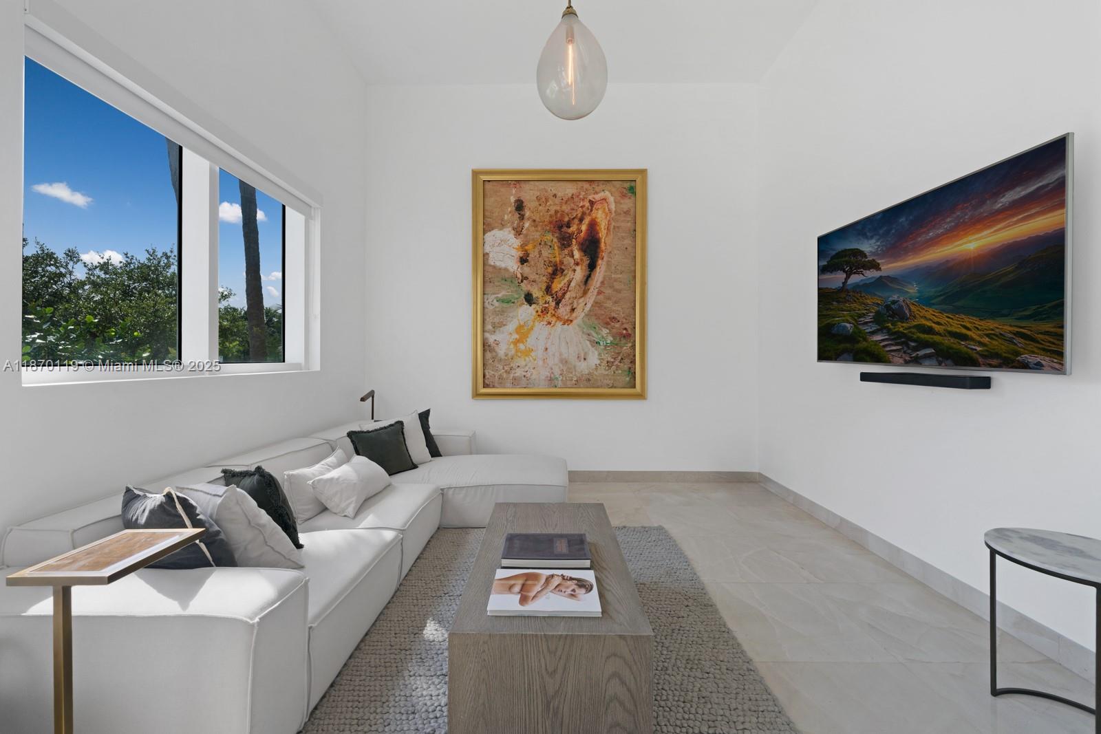 400 Alton Road, Unit TH1A Miami Beach, FL 33139 - Photo 5 of 45 a living room with furniture and a flat screen tv