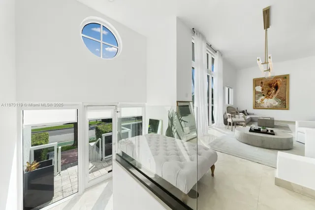 a living room with furniture potted plant and a large window