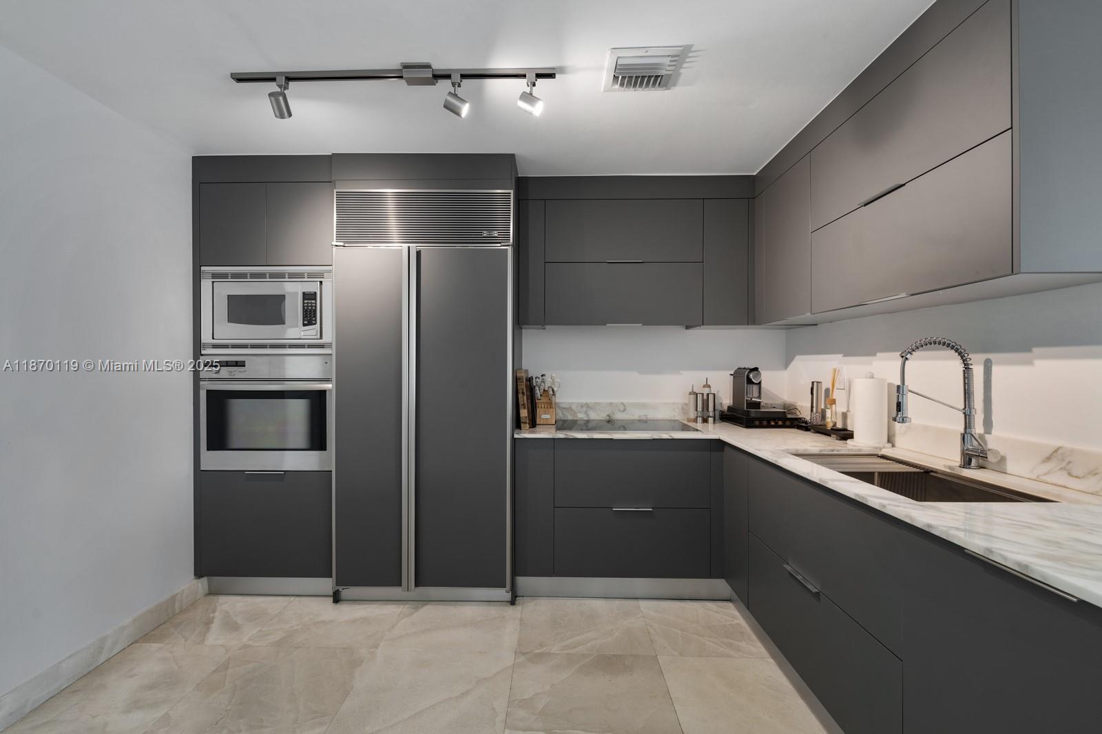 400 Alton Road, Unit TH1A Miami Beach, FL 33139 - Photo 9 of 45 a kitchen with stainless steel appliances granite countertop a refrigerator and a sink