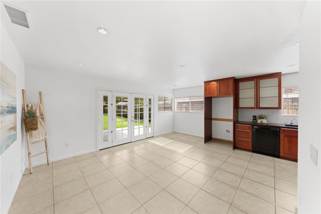 6090 Meadowbrook Lane Riverside, CA 92504 - Photo 13 of 37 Large tiled space with French doors to the backyard, offering an easy indoor-outdoor flow for dining and entertaining.
